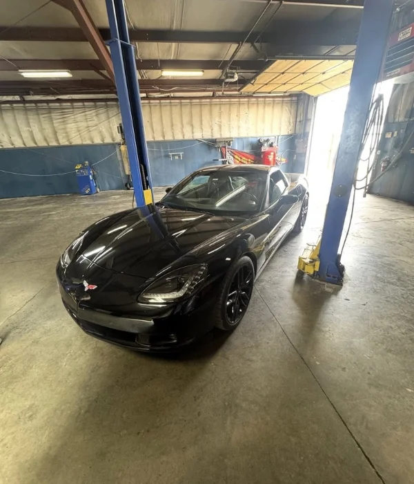 A vehicle up on the lift inside the Total Turf & Auto shop in Topeka, KS